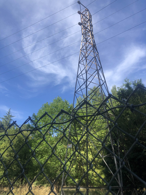 a pylon with clouds swirling above it